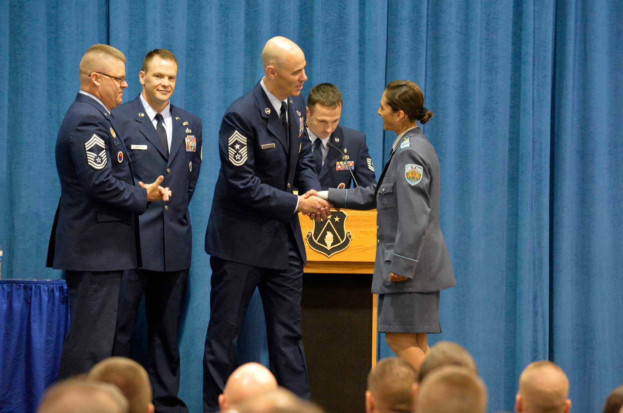 MCGHEE TYSON AIR NATIONAL GUARD BASE, Tenn. - Chief Master Sgt. Ronald C. Anderson, command chief master sergeant, Continental U.S. North American Aerospace Defense Command Region, and 1st Air Force (Air Forces Northern), Tyndall Air Force Base, Fla., congratulates Sergeant Yordanka S. Petrova-Angelova with the Bulgarian air force during a graduation ceremony here for U.S. Air Force Noncommissioned Officer Academy and Airman Leadership School, instructed by the Paul H. Lankford Enlisted PME Center. Petrova-Angelova graduated from NCOA and Bulgarian Corporal Stoyko V. Stoykov graduated from ALS August 15, 2013 as a result of international relations built through the Tennessee National Guard State Partnership Program. (U.S. Air National Guard photo by Master Sgt. Kurt Skoglund/Released)