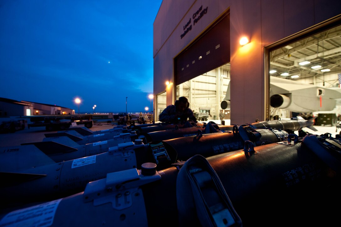 Airman 1st Class Michael Bryant, 28th Aircraft Maintenance Squadron weapons load crew member, secures inert guided bomb units to a munitions trailer during training at Ellsworth Air Force Base, S.D., Aug. 13, 2013. The 28th AMXS is the largest squadron in the 28th Bomb Wing, with more than 700 Airmen supporting Ellsworth’s combat coded B-1 bombers. (U.S. Air Force photo by Airman 1st Class Zachary Hada/Released)