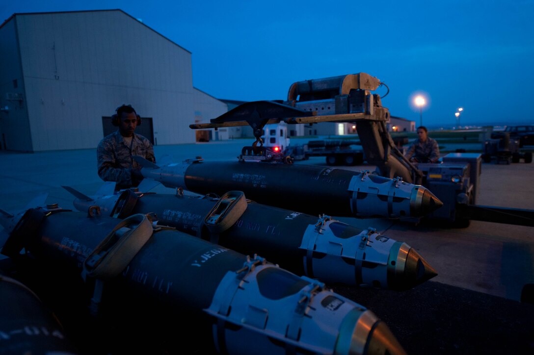 Airman 1st Class Michael Bryant and Senior Airman Tawnielle Childs, 28th Aircraft Maintenance Squadron weapons load crew members, secure inert guided bomb units to a munitions trailer during training at Ellsworth Air Force Base, S.D., Aug. 13, 2013. Weapons load crew Airmen are qualified to operate various special-purpose vehicles designed to transport and handle munitions. (U.S. Air Force photo by Airman 1st Class Zachary Hada/Released)