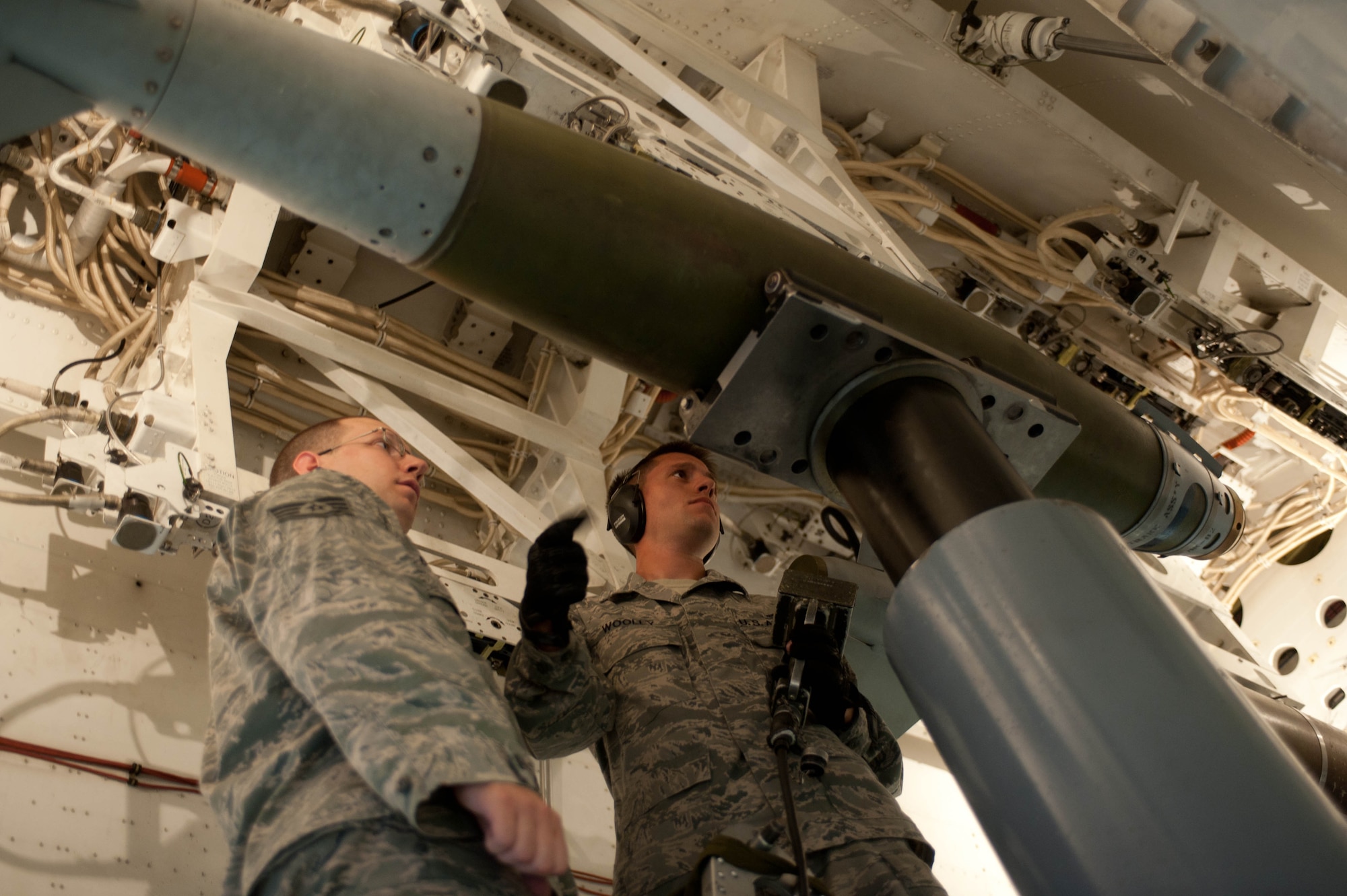 Staff Sgts. Adam Borton (left) and Ryan Wooley, 28th Aircraft Maintenance Squadron weapons load crew members, secure an inert guided bomb unit in a mock B-1 bomber simulator during training at Ellsworth Air Force Base, S.D., Aug. 13, 2013. In addition to initial training, all weapons loaders are evaluated monthly to ensure that they maintain qualification and proficiency in the handling and transportation of munitions. (U.S. Air Force photo by Airman 1st Class Zachary Hada/Released)