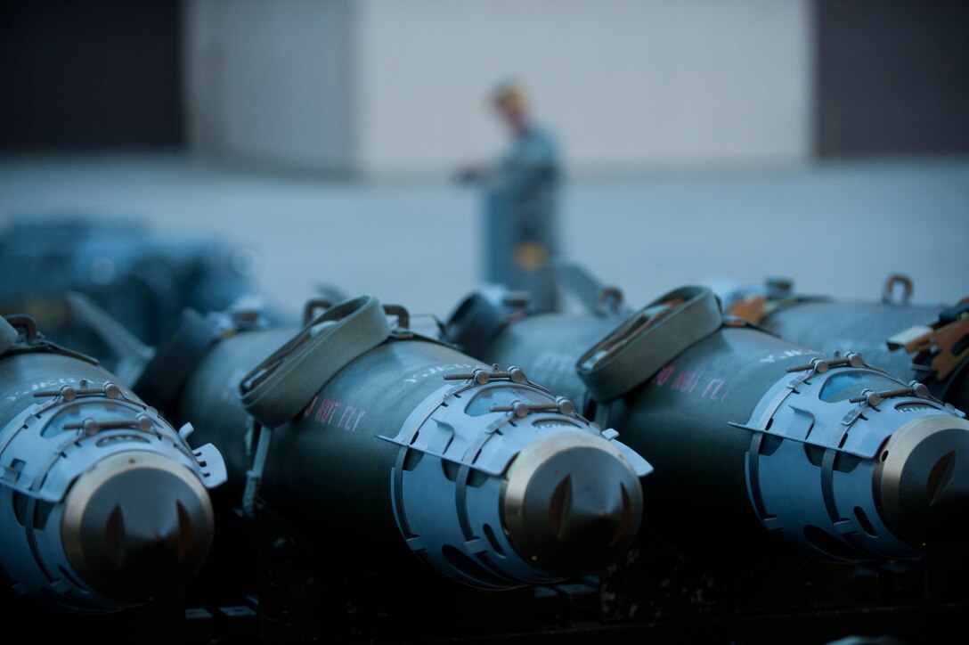 Inert guided bomb units are ready to be loaded into a mock B-1 bomber simulator by weapons load crew Airmen during training at Ellsworth Air Force Base, S.D., Aug. 13, 2013. Weapons load crew Airmen enable each B-1 bomber to deliver a payload of up to 75,000 pounds to mission targets. (U.S. Air Force photo by Airman 1st Class Zachary Hada/Released)