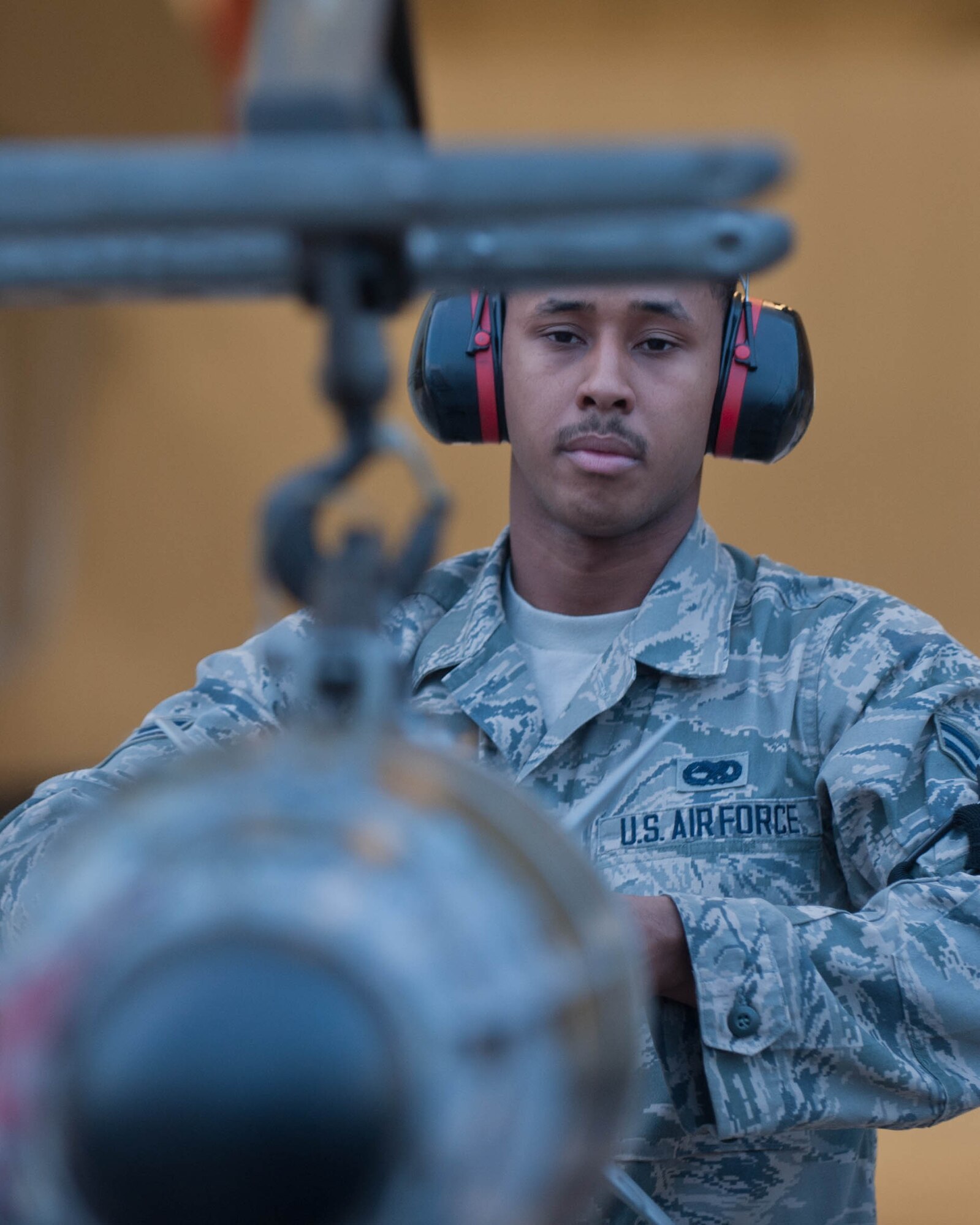 Airman 1st Class Michael Bryant, 28th Aircraft Maintenance Squadron weapons load crew member, secures an inert guided bomb unit to a munitions trailer in the Load Crew Training Facility at Ellsworth Air Force Base, S.D., Aug. 13, 2013. In an effort to prevent mishaps, weapons loading Airmen train daily to strengthen their munitions handling and transporting skills. (U.S. Air Force photo by Airman 1st Class Zachary Hada/Released)