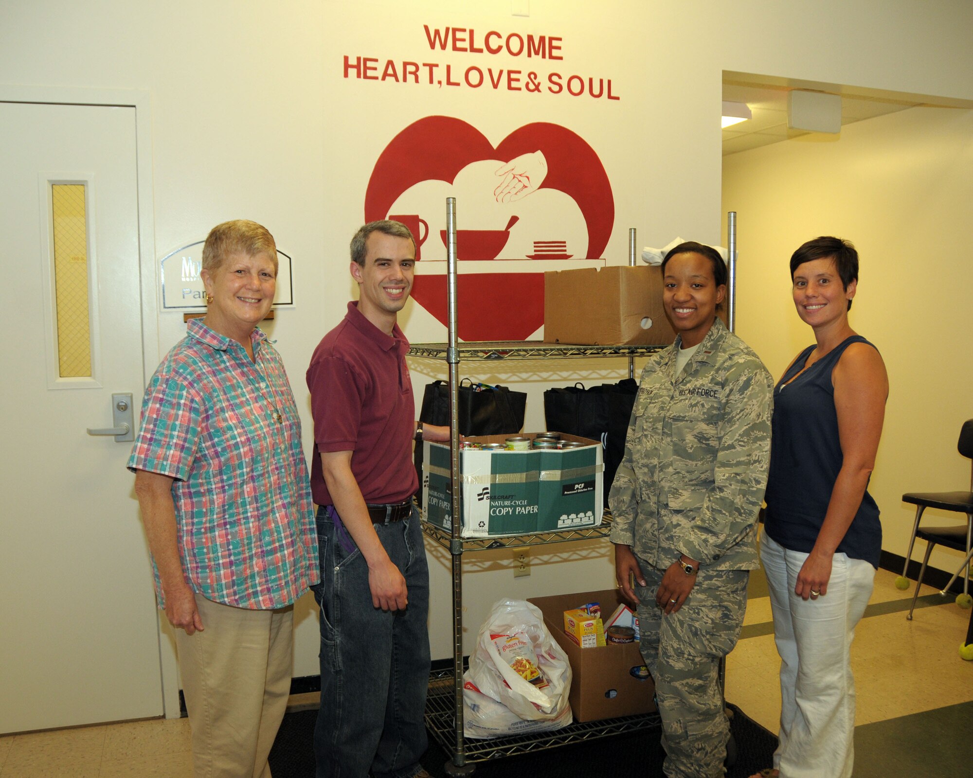 (Left to Right) Sister Beth Brosner, Executive Director, Mr. Michael Daloia, Operations and Personnel Manager, both of Heart, Love and Soul, Inc. pose for a photo with 2nd Lt. Keisha Dobney-Boykin, 914th Force Support Squadron Personnel Officer, and Ms. Megan Calero, 914th Airlift Wing Family Readiness Director at the Heart, Love and Soul Food Pantry in Niagara Falls on August 15, 2013. Members of the 914th generously donated non perishable food items as part of the Feds Feed Families program. The 914th members delivered the items and were gladly accepted by the food pantry. (U.S. Air Force photo by Peter Borys)