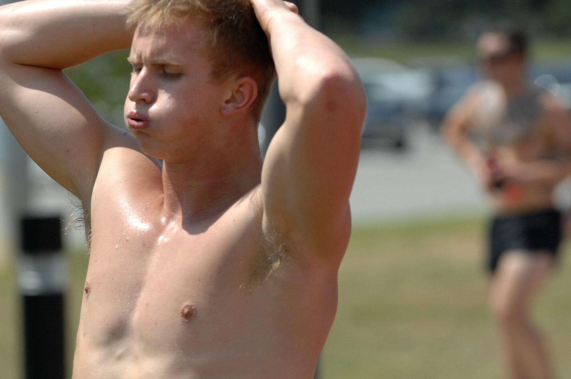 U.S. Air Force Airman 1st Class Austin Hager, 4th Logistics Readiness Squadron vehicle operations journeyman, cools down after completing the running portion of a Physical Ability and Stamina Test (PAST) at Seymour Johnson Air Force Base, N.C., Aug. 12, 2013.  Hager was attempting to qualify for a Combat Controller position, which requires Airmen to complete a 1.5 mile run in 10 minutes, 10 seconds or faster.  (U.S. Air Force photo by Airman 1st Class Brittain Crolley/Released)