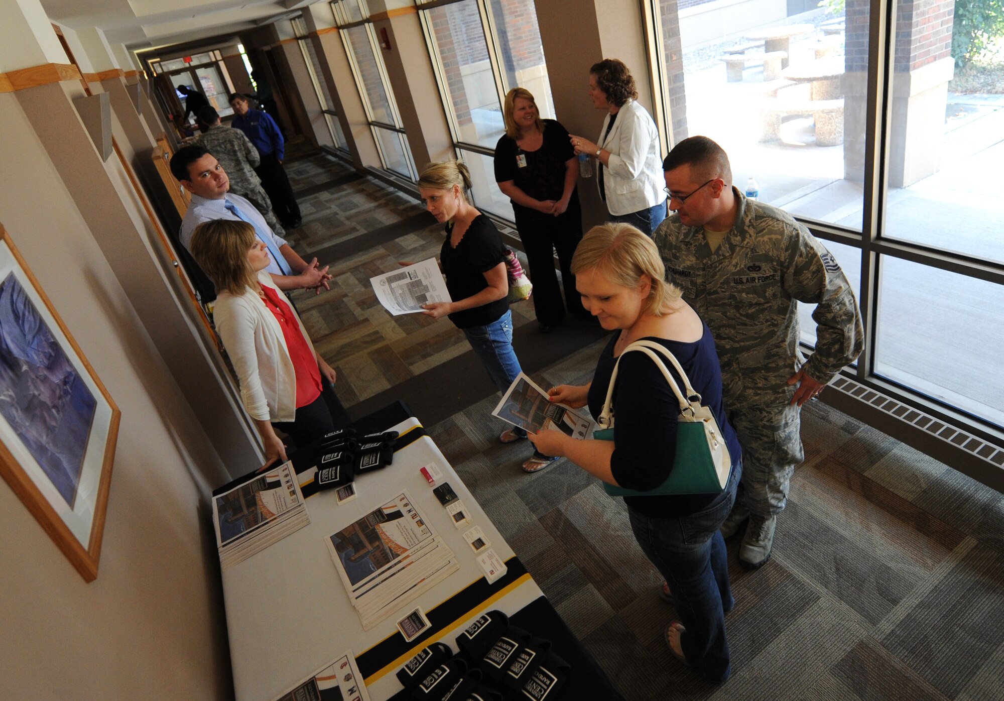 Airmen, family members and civilians visit information booths during an education fair in the Rushmore Center at Ellsworth Air Force Base, S.D., Aug. 14, 2013. The fair was designed to provide attendees with an opportunity to explore and learn more about the many colleges offering courses in the area during the upcoming fall semester. (U.S. Air Force photo by Airman 1st Class Hrair H. Palyan/Released)