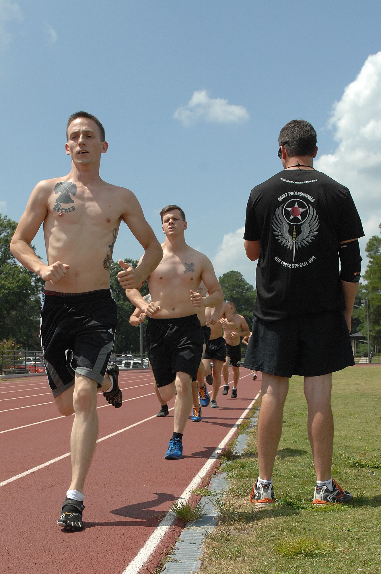 U.S. Air Force Airmen assigned to Seymour Johnson Air Force Base perform the running portion of a Physical Ability and Stamina Test (PAST) at Seymour Johnson Air Force Base, N.C., Aug. 12, 2013.  Completing the PAST requires Airmen to test their abilities in swimming, running, pull-ups, sit-ups and push-ups.  (U.S. Air Force photo by Airman 1st Class Brittain Crolley/Released)
