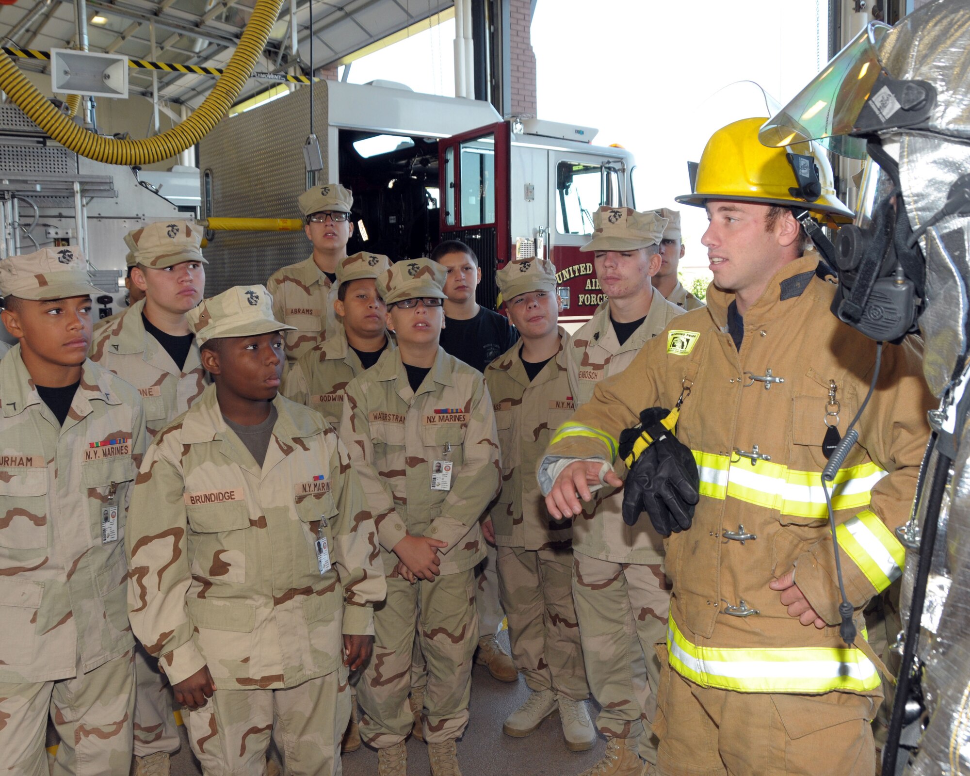 Firefighter Kyle Savage, Niagara Falls Air Reserve Station Fire Department speaks to members of the Niagara Youth Marine Cadets while on tour at the Air Station on August 15, 2013. The group visited the base recently which included s security forces, fire fighting, and explosive ordinance disposal demonstration. (U.S. Air Force photo by Peter Borys)