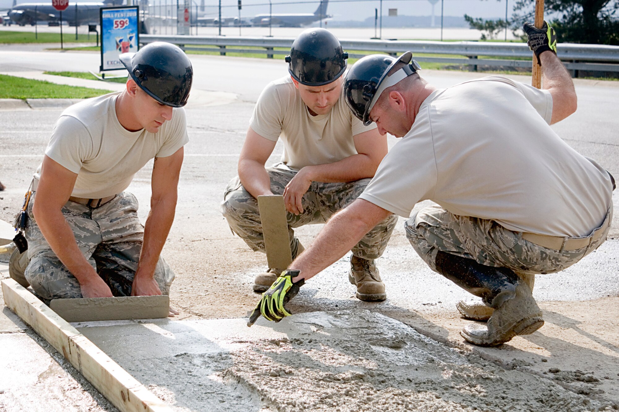 Senior Master Sgt. Nate Colborn, 434th Civil Engineer Squadron structural superintendent, right, provides training to members of his construction crew Aug. 8, 2013 at Grissom Air Reserve Base Ind. Senior Airman Alex Barone,  pavements and construction equipment apprentice, left, and Tech. Sgt. Ron Maxwell, structural repair journeyman, were part of a team that expanded the patio between the 434th Maintenance Group command section and the base exchange at Bldg. 595. (U.S. Air Force photo/Tech. Sgt. Doug Hays)