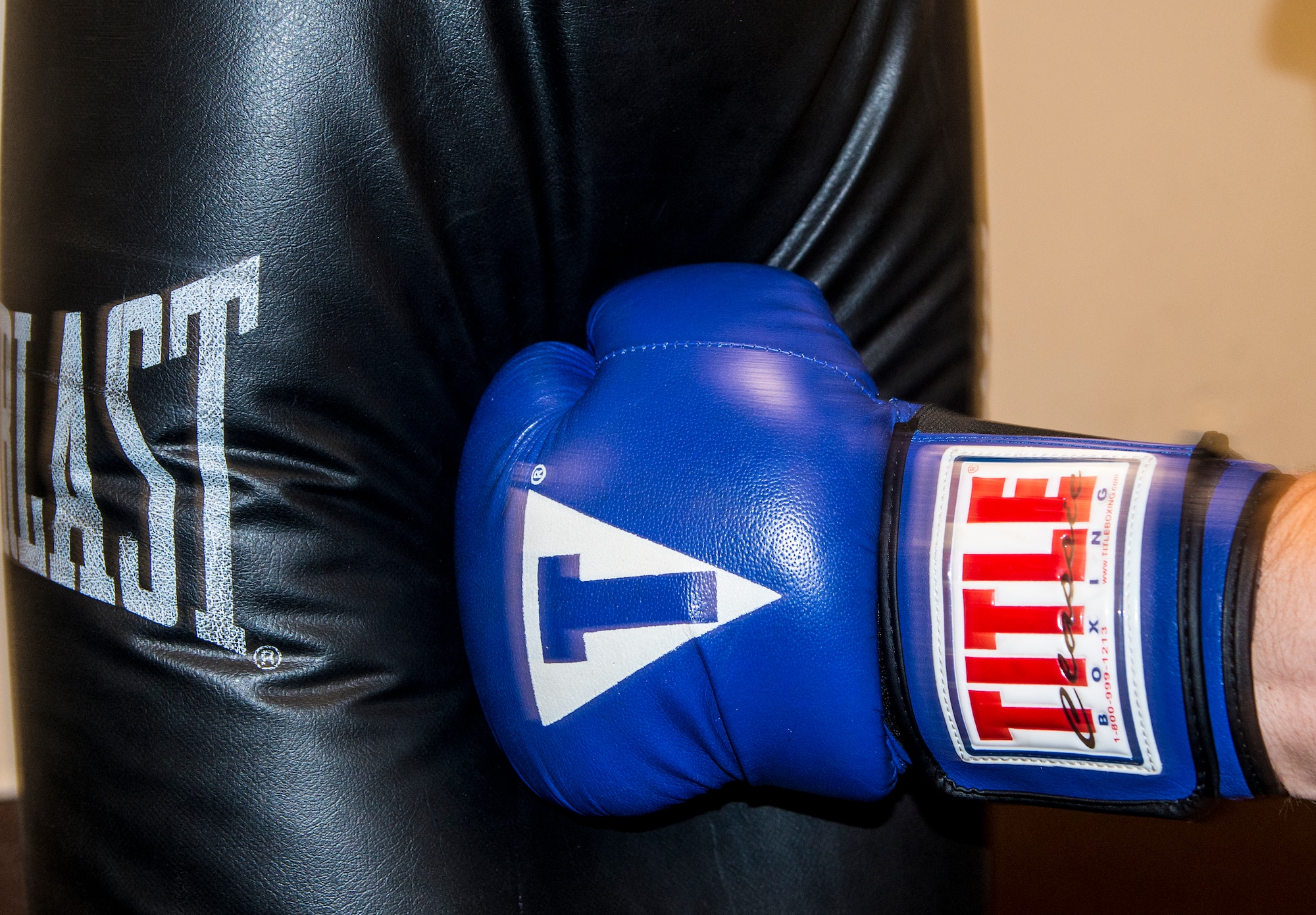 A boxing glove strikes a punching bag in the Freedom I Fitness Center at Moody Air Force Base, Ga., June 27, 2013. In many combat sports, the heavy bag is used as a way to develop power and striking technique. (U.S. Air Force photo by Senior Airman Douglas Ellis/Released)
