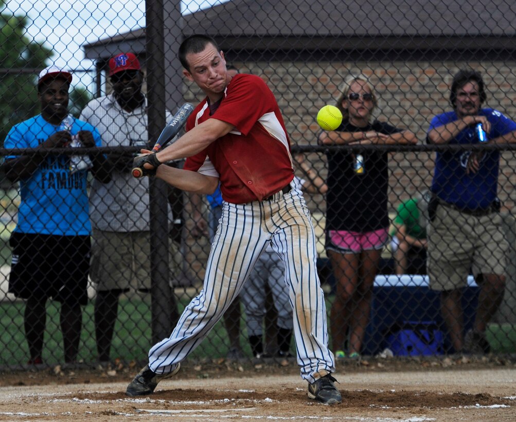 Senior Airman Adam Hughes, shortstop for the 811th Security Forces Squadron, hits the ball during the Joint Base Andrews Intramural Slow-pitch Softball Championship game at Joint Base Andrews, Md., August 14, 2013. The 811th SFS beat the 113th Wing D.C. Air National Guard 22-5 in the first game double-elmination game, before losing the championship 22-6 the next game. (U.S. Air Force photo/Airman 1st Class Nesha Humes)(Released)