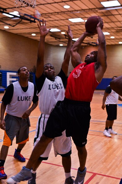 Delbert Coburn, 56th Civil Engineer Squadron, shoots the ball after getting the rebound during an intramural basketball game against the 56th Contracting Squadron team Aug. 5 at the Luke Air Force Base Bryant Fitness Center. Coburn also continues to play softball after losing his left eye. (U.S. Air Force photo/Senior Airman David Owsianka)