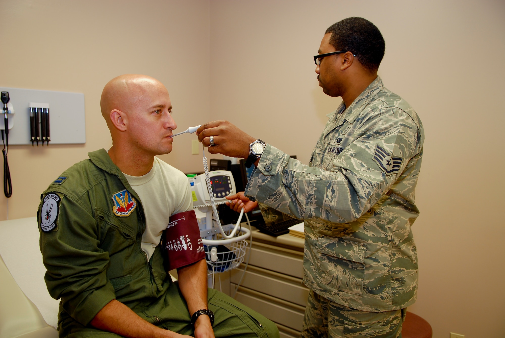 Staff Sgt. Jovanny Reyes, 56th Aerospace Medicine Squadron aerospace medicine technician, takes the vitals of Capt. George Normandin, 56th Training Squadron instructor pilot, Aug. 9 at flight medicine on Luke Air Force Base. Airmen with the 56th AMDS are responsible for ensuring all aviation-associated personnel are taken care of medically. (U.S. Air Force photo/Senior Airman Grace Lee)