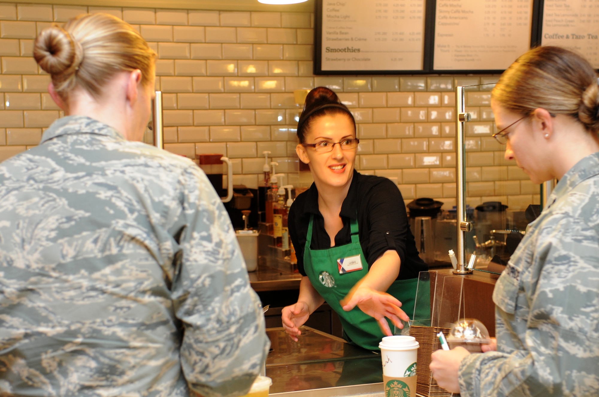 Ljuljjeta Sabani, Starbucks barista, serves up a beverage to Luke Air Force Base Airmen Tuesday inside the exchange mall. The exchange mall offers a wide variety of food and beverage choices for military members, civilians and family members. (U.S. Air Force photo/Staff Sgt. Nestor Cruz)