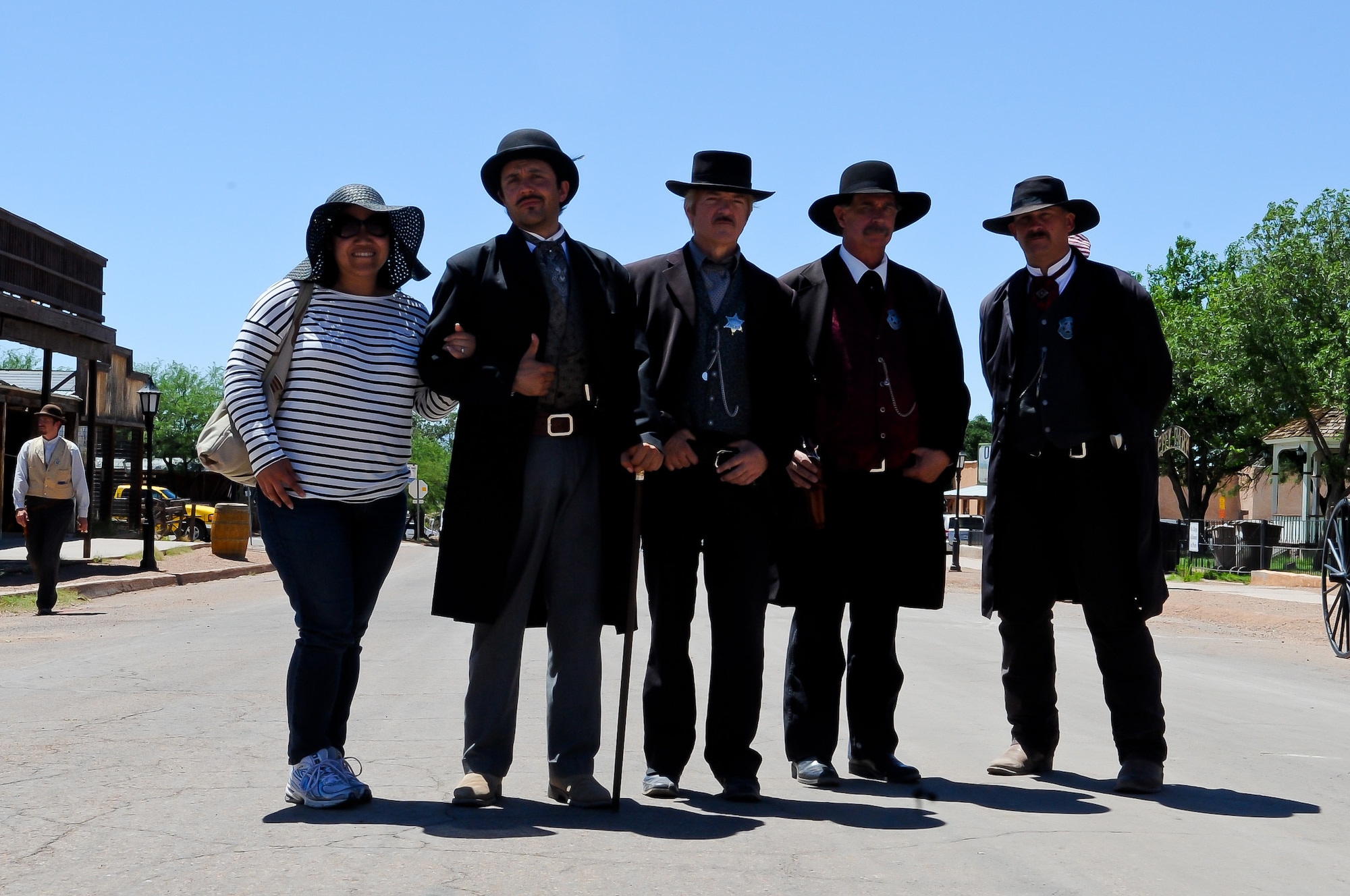 Actors dressed as Doc Holliday and the Earp brothers pose for a photo with a visitor on the main street of Tombstone. Re-enactments of the legendary “Gunfight at OK Corral” are held inside the OK Corral on Allen Street at noon, 2 and 3:30 p.m. most days. (U.S. Air Force photo/Staff Sgt. Nestor Cruz)