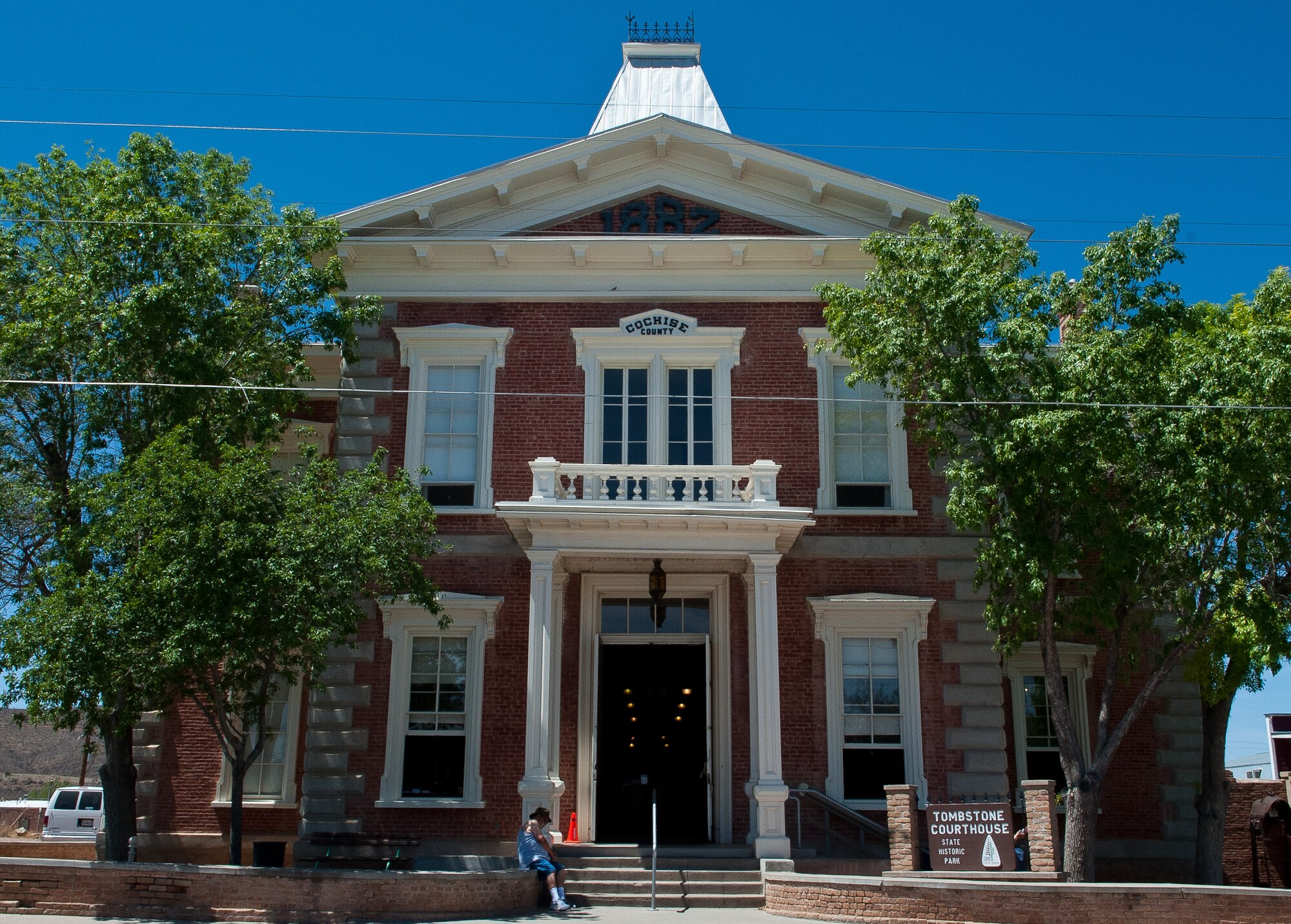 A visitor rests in the shade at the Tombstone Courthouse State Historic Park. The two-story courthouse building once housed the offices of the sheriff, recorder, treasurer, jail and courtrooms of Cochise County. The park includes a museum, gift shop and a replica of the gallows in the courtyard where hangings were conducted back in the 1880s. (U.S. Air Force photo/Staff Sgt. Nestor Cruz)