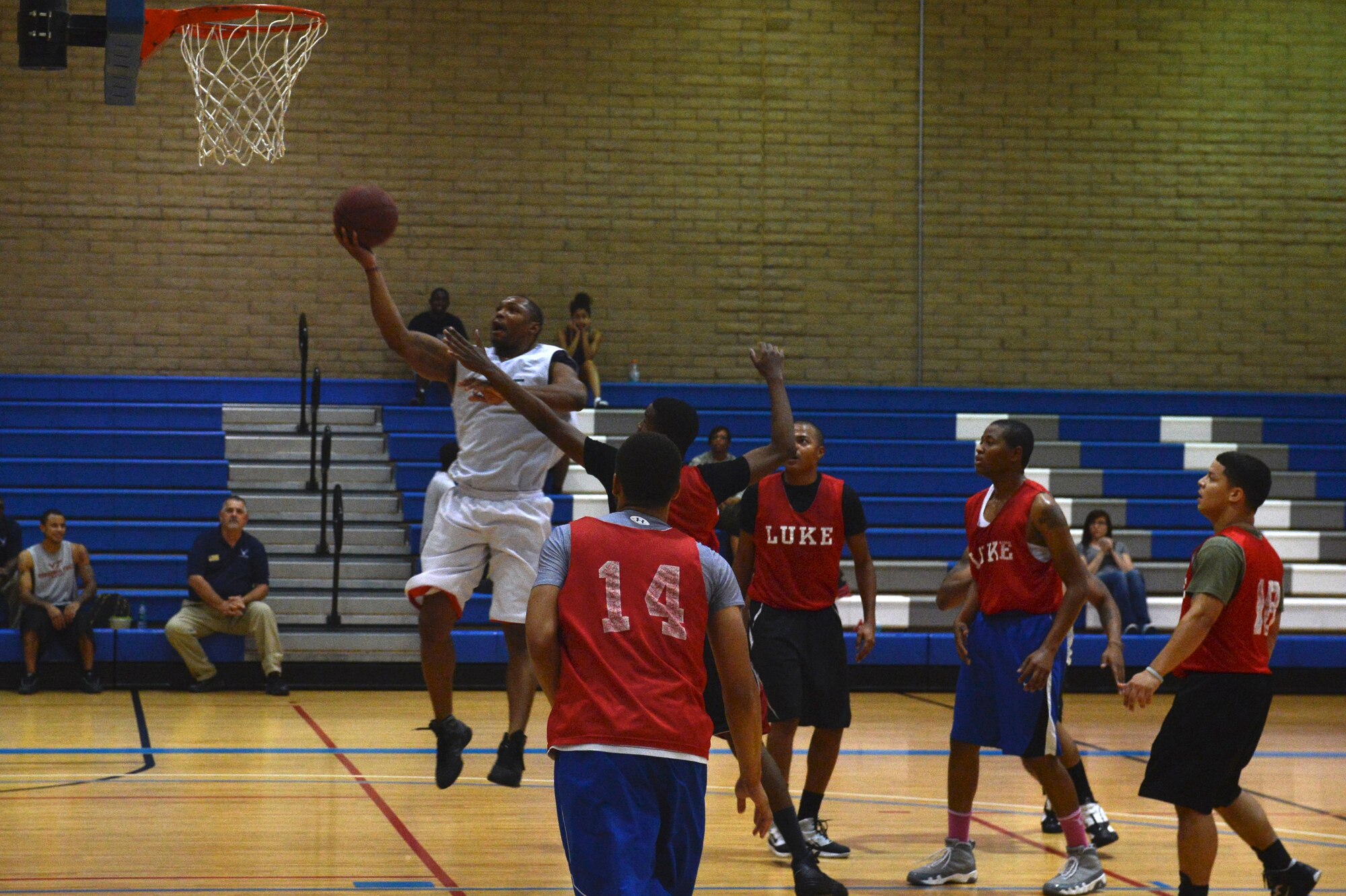 Jabari Johnson, 56th Civil Engineer Squadron, avoids defenders during a game Aug. 7 against the 56th Logistics Readiness Squadron team at the Luke Air Force Base Bryant Fitness Center. CES defeated LRS 55-49. (U.S. Air Force photo/Airman 1st Class James Hensley)