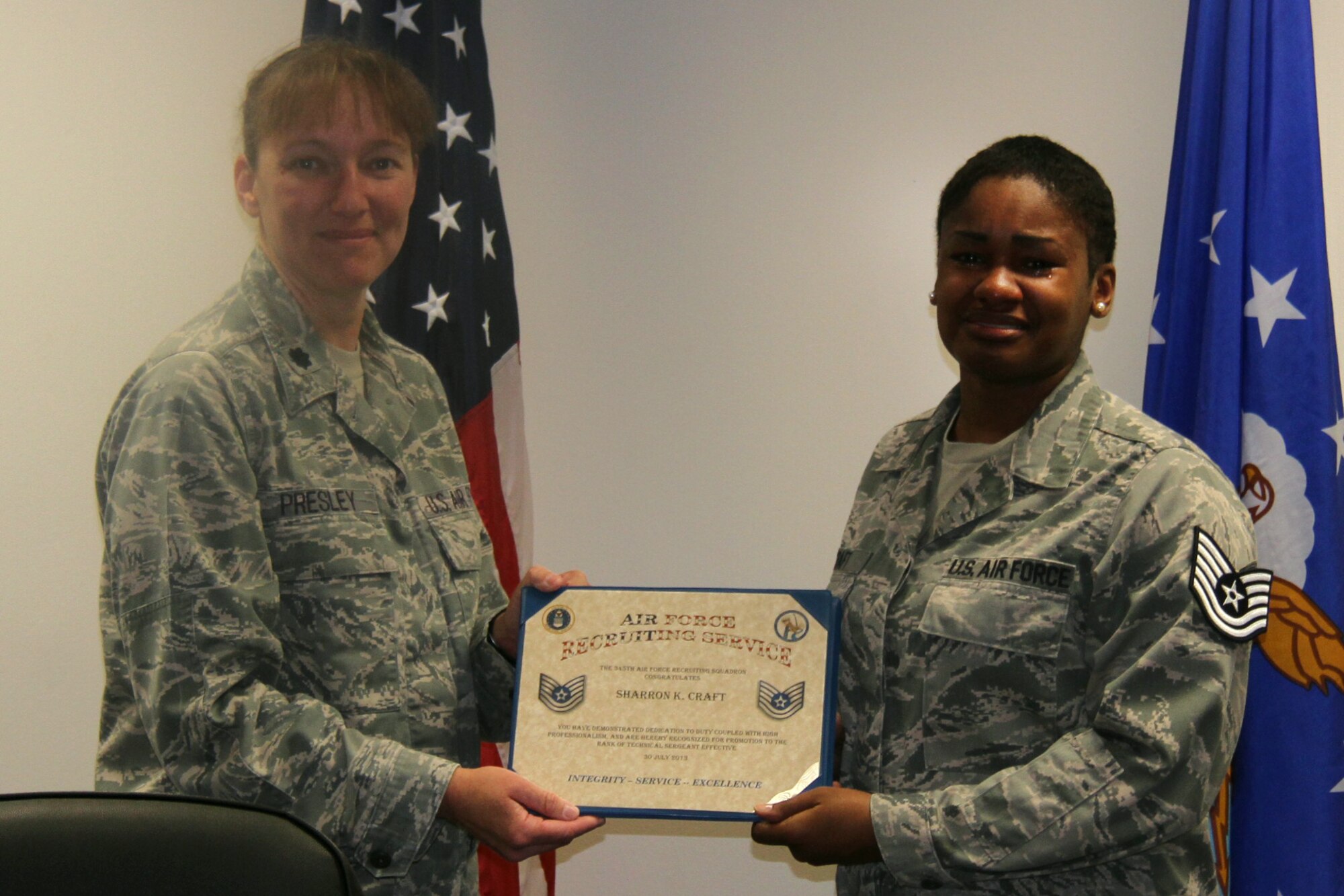 Lt. Col. Sharon Presley, 345th Recruiting Squadron commander (left) presents Staff Sgt. Sharron Craft, 345th RCS operations noncommissioned officer, a certificate following her promotion to technical sergeant through the Stripes for Exceptional Performers program July 31. Craft had recently joined the 345th RCS after completing her tour as a 342nd RCS health professions recruiter, and was still in-processing when the surprise promotion occurred. (U.S. Air Force photo/Tech. Sgt. Daniel Hopper)
