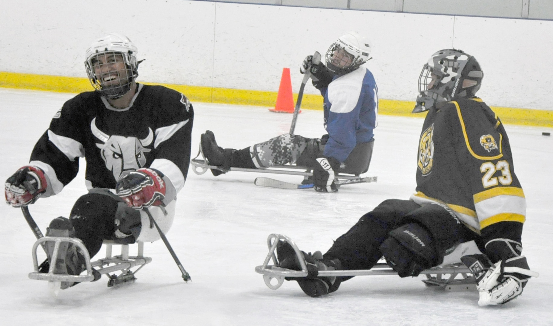 San Antonio Rampage sled hockey defenseman Rico Roman (left) is all smiles as he scores a goal on the Rampage’s goaltender, Jen Yung Lee (right), during a practice session July 31. Roman, Lee and Joseph Sweeney (not shown), have been selected to represent Team USA at the 2014 Paralympic Winter Games in Sochi, Russia from March 7-16, 2014. (Photo by Robert Shields, Brooke Army Medical Center Public Affairs)