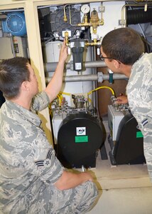 Senior Airman Zachary Baggerly (left) and Airman 1st Class Melvin Hill troubleshoot an oxygen concentration unit in the Information Technology and Field Support Equipment Course. This is one of 12 courses service members must complete during Biomedical Equipment Maintenance Technician training at the Medical Education and Training Campus on Joint Base San Antonio-Fort Sam Houston. (Photo by Lori Newman, JBSA-Fort Sam Houston Public Affairs)
