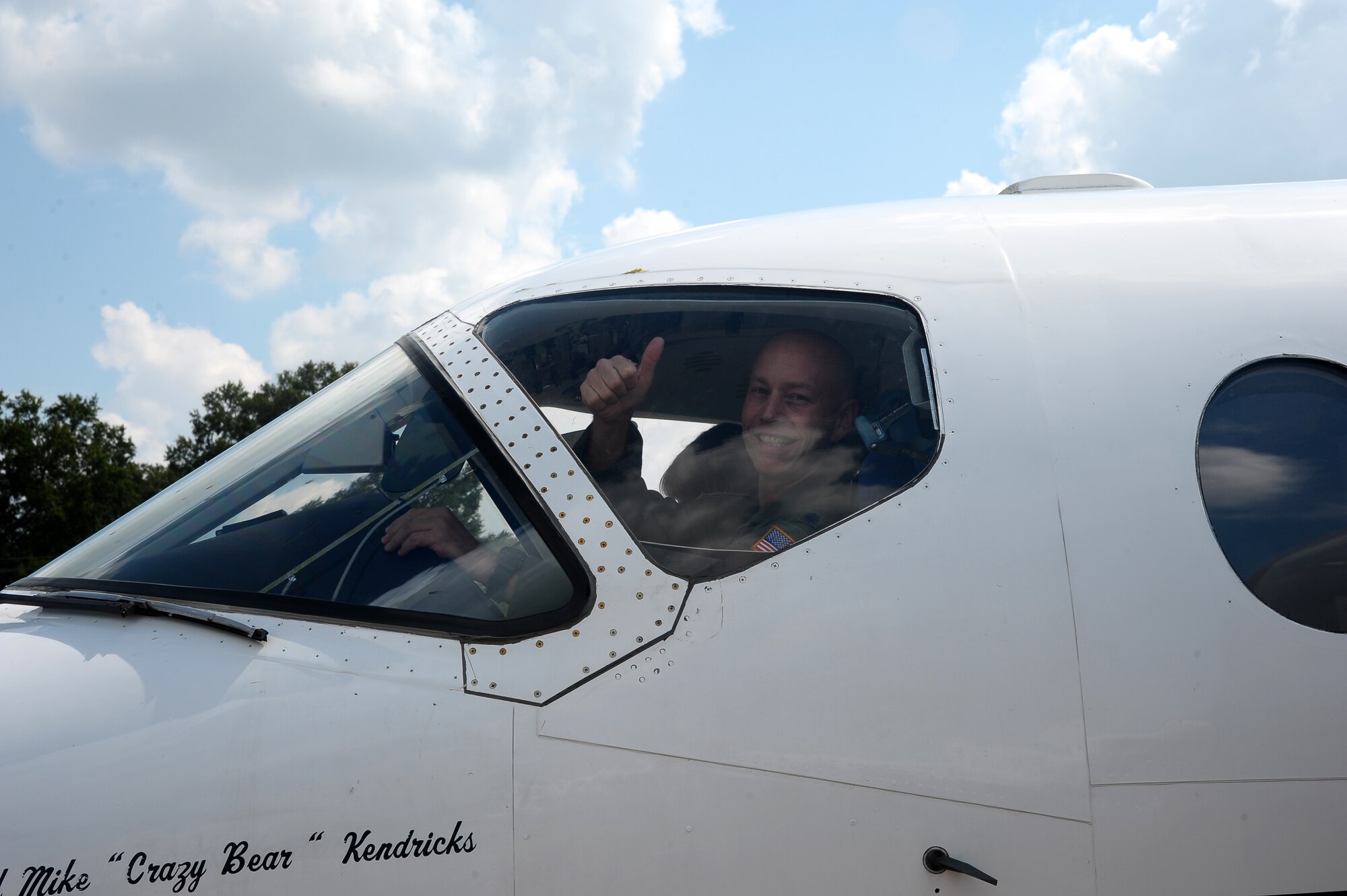 Lt. Col. Michael Kendrick, 43rd Flying Training Squadron, glances out the window of a T-1A Jayhawk after landing from his fini-flight Aug. 14 on the Columbus Air Force Base flight line. The fini-flight is a military aviation tradition and here marked Kendricks’s retirement from the Air Force upon completion of his final flight on Columbus AFB. Upon completion of the fini-flight, it is tradition to spray down or douse the pilot in water upon leaving the aircraft. (U.S. Air Force Photo/Airman 1st Class Stephanie Englar)