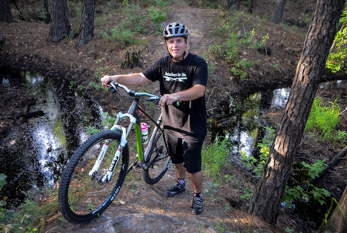 Tech. Sgt. Nathan Swab, 628th Communications Squadron quality assurance evaluator and a Low Country Fat Tire Freaks member, takes a break while navigating the trails at Marrington Plantation,  Aug. 13, 2013, on Joint Base Charleston - Weapons Station, S.C. The Marrington trail system is more than 19 miles long and has an average of 6,000 visitors a year. The LCFTF is a group of volunteers who help maintain the trails. (U.S. Air Force photo/Senior Airman Jared Trimarchi) 
