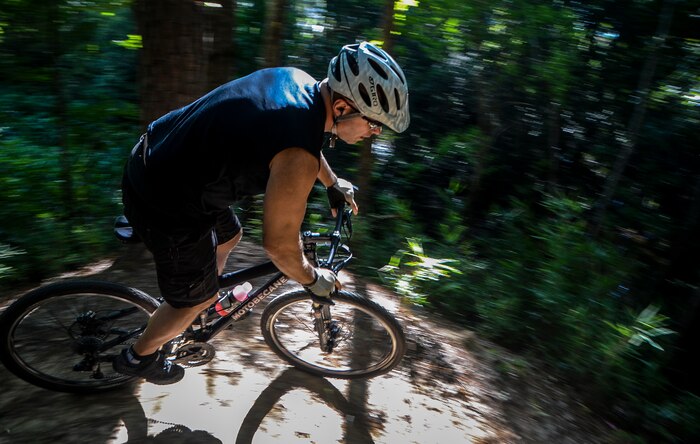 Retired Air Force Tech. Sgt. Terry Walsh, and member of the Low Country Fat Tire Freaks, rides down a slope Aug. 11, 2013, at Marrington Plantation on Joint Base Charleston - Weapons Station, S.C. The Marrington trail system is more than 19 miles long and has an average of 6,000 visitors a year. The LCFTF is a group of volunteers who help maintain the trails. (U.S. Air Force photo/Senior Airman Jared Trimarchi) 