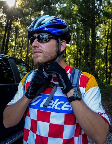 Jon Finney, a member of the Low Country Fat Tire Freaks, secures his helmet at Marrington Plantation, Aug. 11, 2013, on Joint Base Charleston - Weapons Station, S.C. The Marrington trail system is more than 19 miles long and has an average of 6,000 visitors a year. The LCFTF is a group of volunteers who help maintain the trails. (U.S. Air Force photo/Senior Airman Jared Trimarchi) 