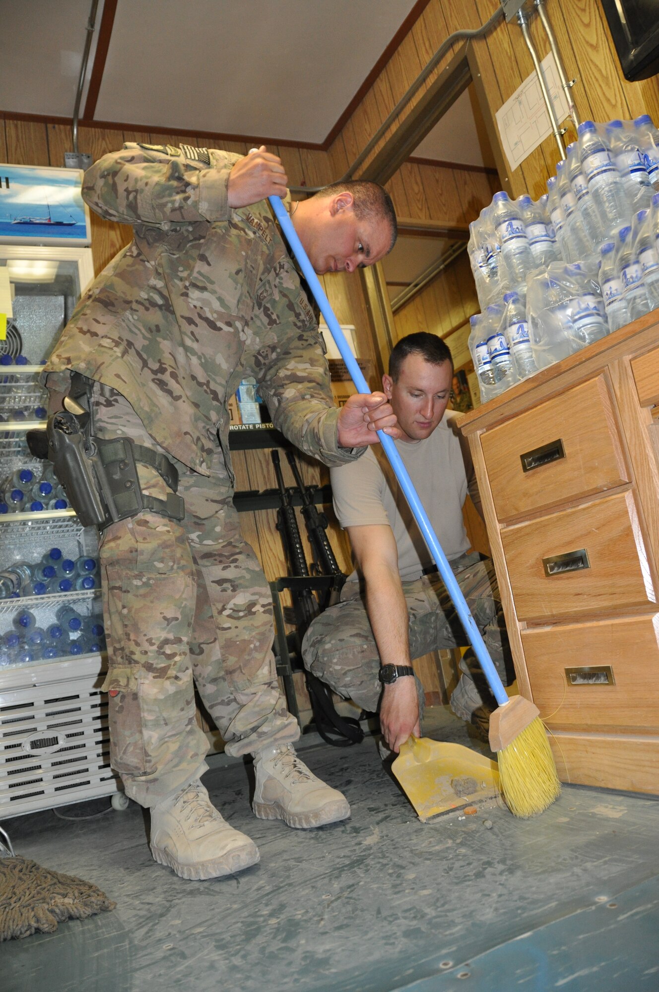 Master Sgt. John Van Pelt, 183d Security Forces Squadron Guard non-commissioned officer in charge of Echo Sector and Senior Airman Gregory Skrjanc, 455th Expeditionary Security Forces Squadron Echo controller, are deployed to Bagram Airfield, Afghanistan. The service members volunteered their time during the 'Spring Cleaning in the Fall' project that organized and rearranged the Airman Ministry Center here Aug. 16, 2013. (U.S. Air Force Photo/Tech. Sgt. Rob Hazelett)