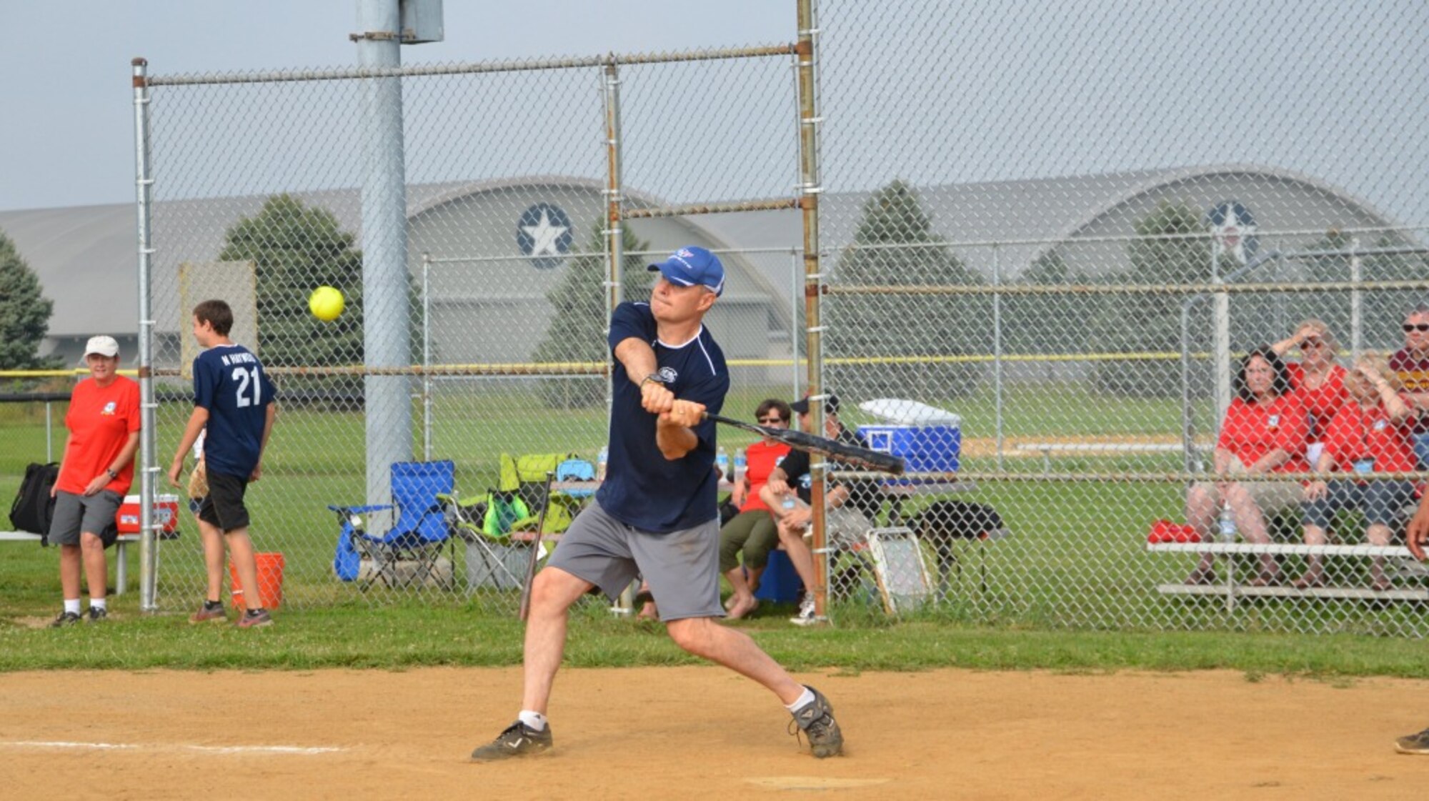 Brig. Gen. James Haywood, AFSAC director, swings for the fences during the annual softball game. The Air Force Life Cycle Management Center’s Air Force Security Assistance and Cooperation Directorate and their assigned Foreign Liaison Officers have played each other in an annual game of softball since 1984.  (photo by Patty Long)