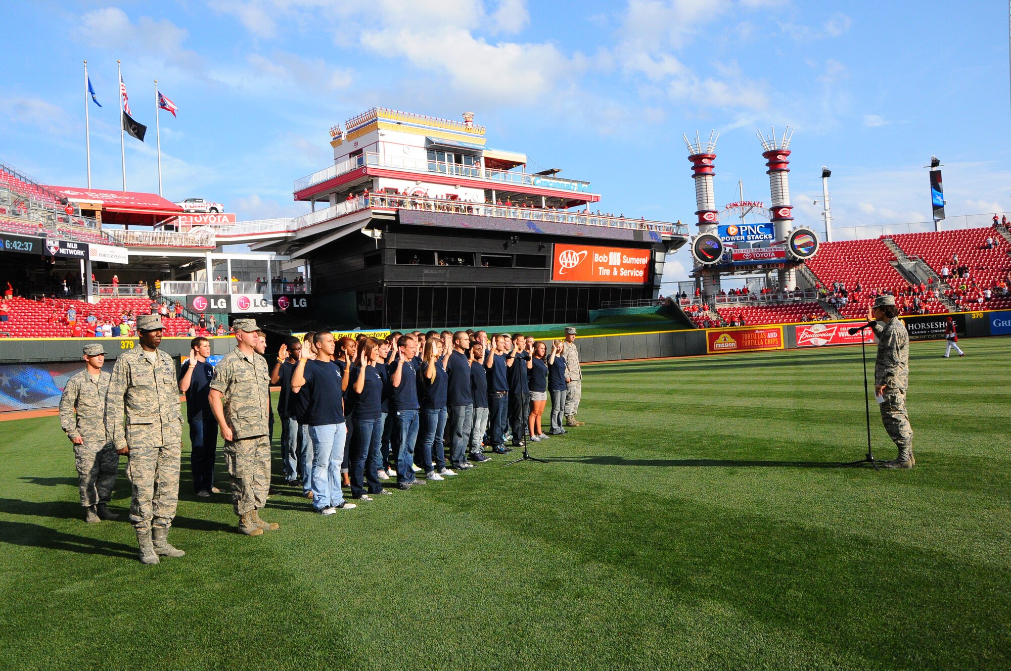 Col. Cassie Barlow, 88 Air Base Wing commander, swears in 35 delayed entry program members as part of the pre-game ceremonies.  (photo by Niki Jahns)