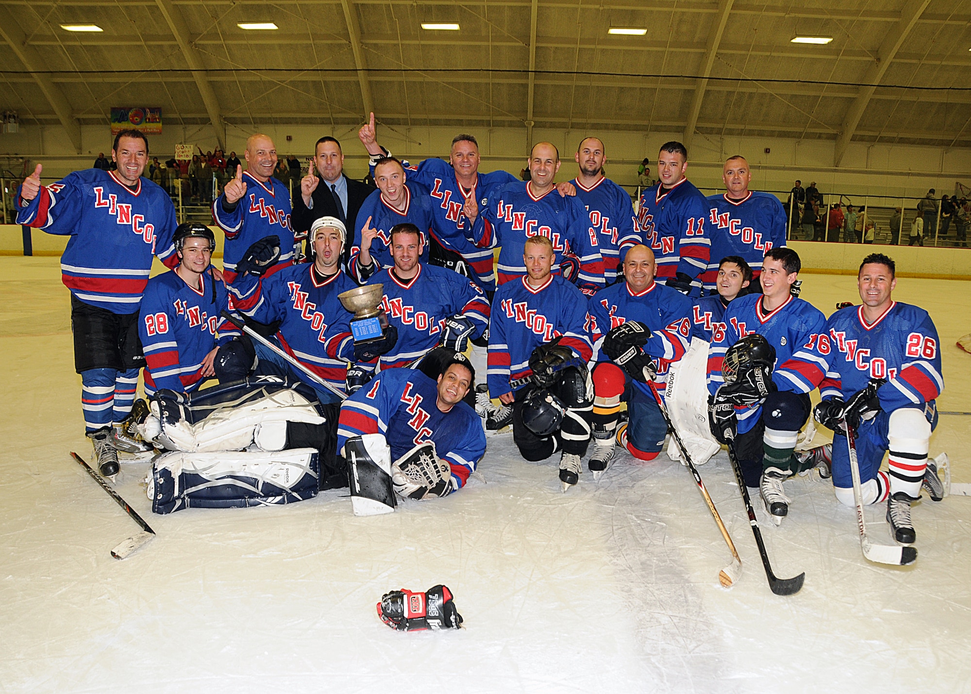 Members of the RI Air National Guard hockey team pose for a team photo after their victory at the General's Cup Hockey Tournament. The tournament is played each year between the Rhode Island Army and Air National Guard as a charity event. The game was played this year to benefit United States Marine Corps Corporal Kevin Dubois, a native of Lincoln, RI who was wounded in battle, via Homes for Our Troops. The Air Guard took the cup in a 6-5 double shoot out win. National Guard Photo by Master Sgt. Janeen Miller (RELEASED)