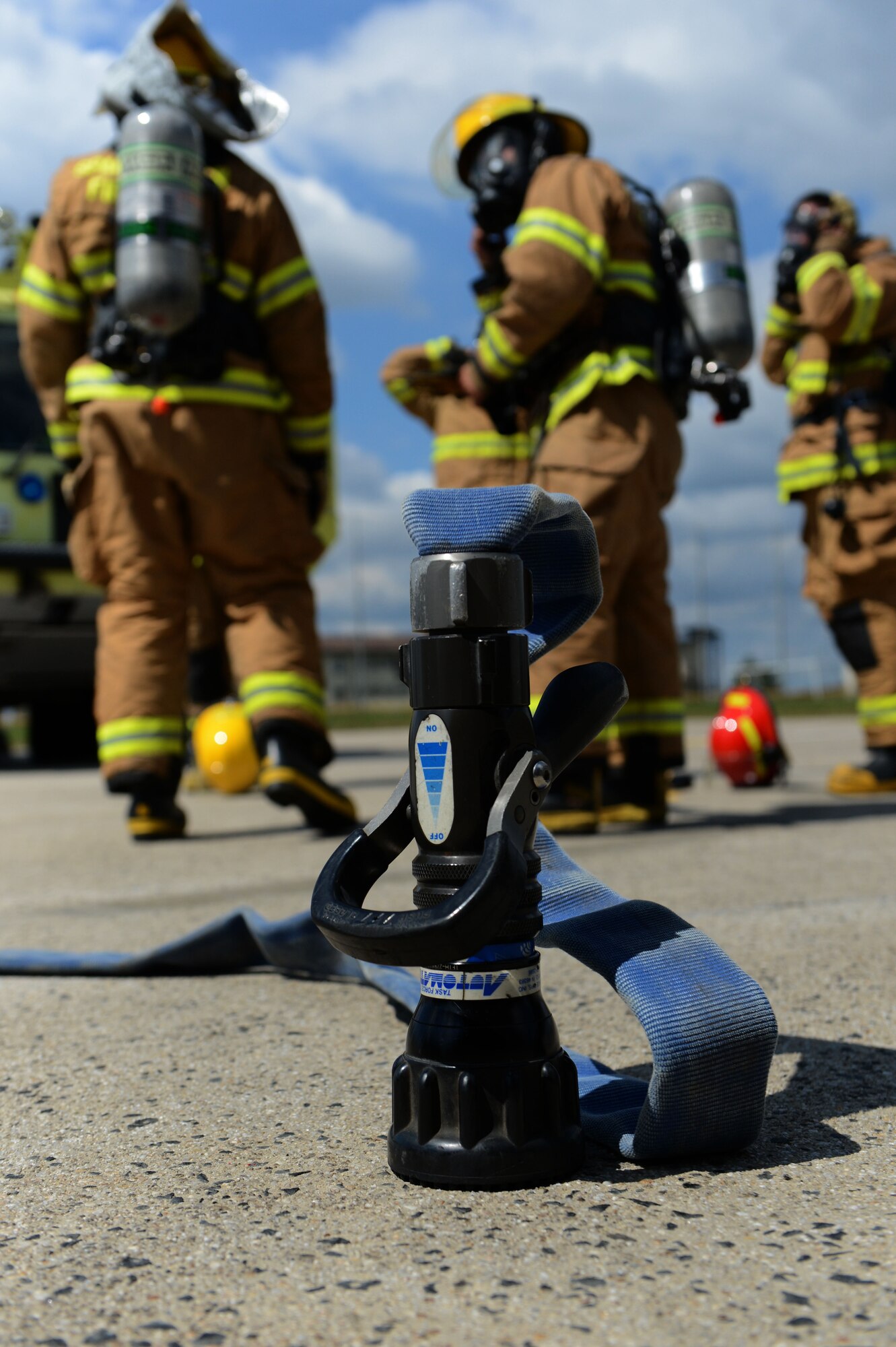 SPANGDAHLEM AIR BASE, Germany – Firefighters from the 52nd Civil Engineer Squadron gather after an aircraft fire training exercise Aug. 14, 2013. This type of training is held on a routine basis to ensure fire technicians are prepared for real-world scenarios. (U.S. Air Force photo by Airman 1st Class Gustavo Castillo/Released)