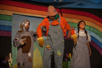 Toto, played by Caitlin Ashbaugh (left), daughter of Christy Ashbaugh, and Dorothy, played by Alyza Ablang (right), daughter of Master Sgt. Maria Ablang, 628th Aerospace Medicine Squadron, and Tech. Sgt. Paolo Ablang, 628th AMDS, participate in the stage production of “The Wizard of Oz” Aug. 2, 2013, produced by the Missoula Children's Theatre and the Youth Programs Center at Joint Base Charleston- Weapons Station, S.C. The Missoula Children's Theatre International Tour has fostered development life skills in more than a million children. This year alone, the Missoula Children Theatre will work with 65,000 children in more than 1,200 communities in all 50 states and 17 countries. (U.S. Air Force photo/Senior Airman Ashlee Galloway)