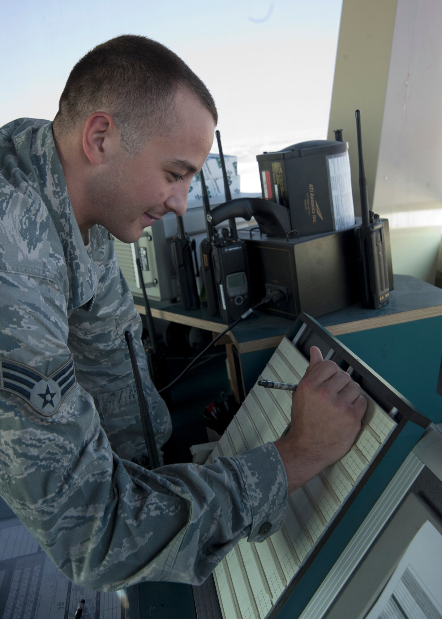 Senior Airman Kevin Krippner fills out a flight progress strip used to keep track of aircraft entering and exiting the airfield at the 379th Air Expeditionary Wing in Southwest Asia, Aug. 13, 2013. Krippner is a 379th Expeditionary Operations Support Squadron air traffic controller deployed from Holloman Air Force Base, N.M., and hails from Winchester, Va. (U.S. Air Force photo/Senior Airman Bahja J. Jones)