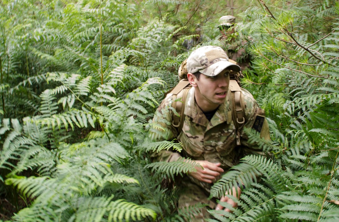 Staff Sgt. Jacob Schmidt, 352nd Special Operations Support Squadron Survival, Evasion, Resistance and Escape specialist, leads Airmen from the 352nd Special Operations Group through the woods during combat survival training at Stanford Training Area, England, Aug. 6, 2013. The training covered other aspects of combat survival such as land navigation and evasion tactics. (U.S. Air Force photo by Staff Sgt. Stephen Linch)