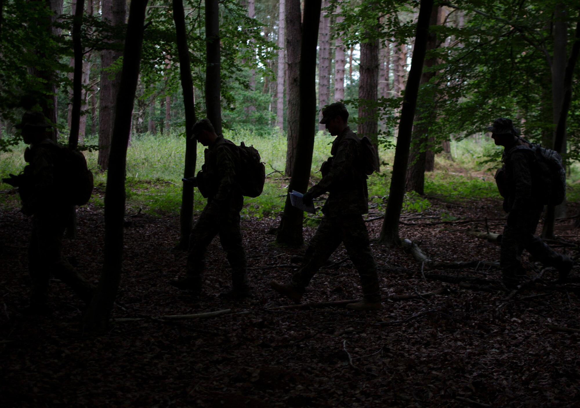 Airmen from the 352nd Special Operations Group navigate to a training location during combat survival training at Stanford Training Area, England, Aug. 6, 2013. A 352nd SOG survival, evasion, resistance and escape specialist led the training. (U.S. Air Force photo by Staff Sgt. Stephen Linch)