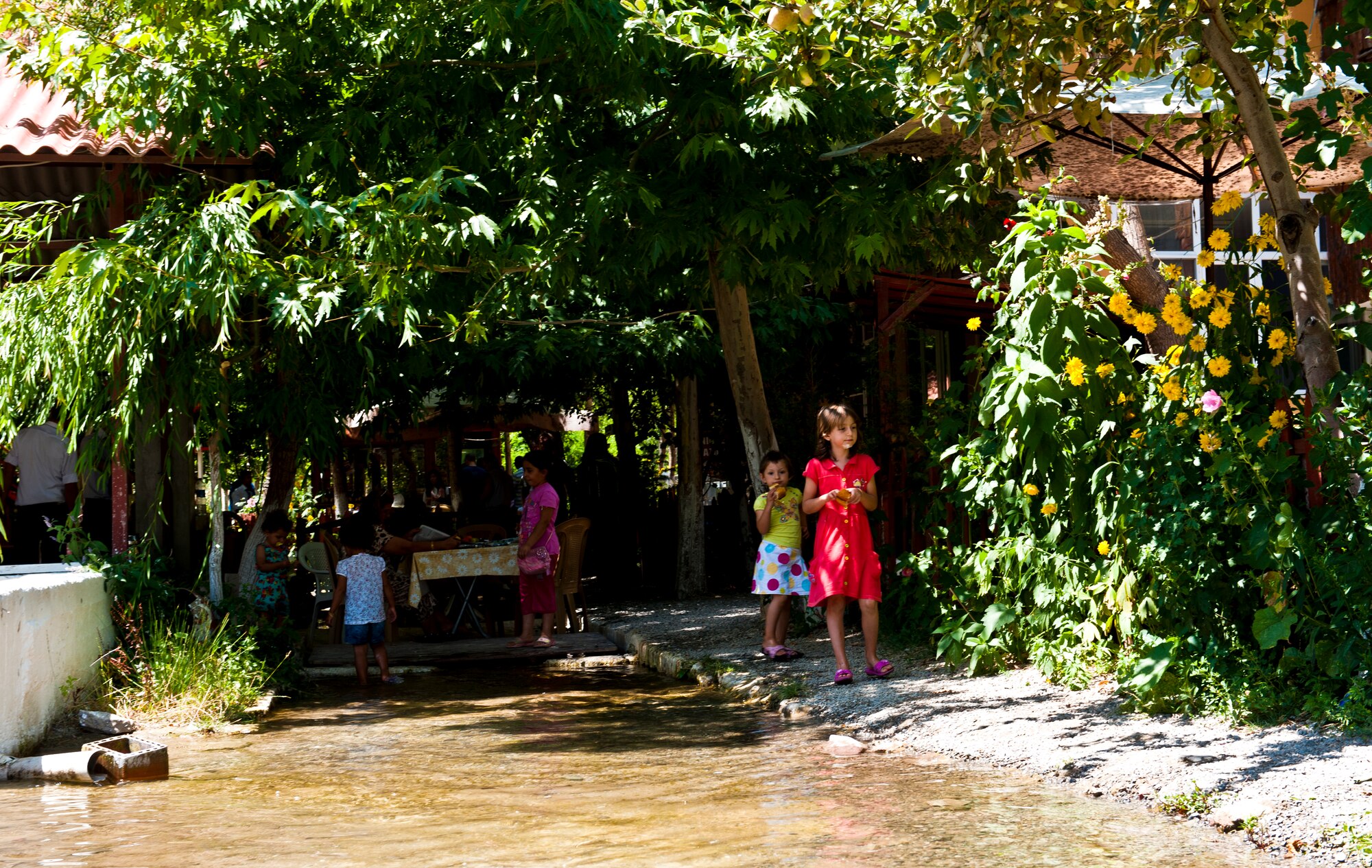 Children look at flowers growing in Saklibahce Aug. 11, 2013, at Pozanti, Turkey. Saklibahce provides a welcoming environment for families to relax and get away. (U.S. Air Force photo by Senior Airman Daniel Phelps/Released)