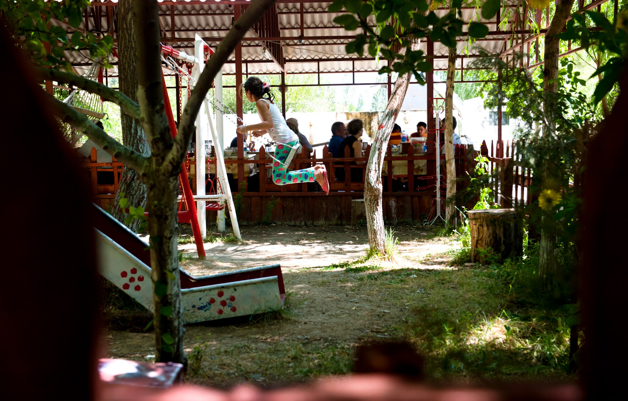 A child swings on a swing set in the park at Saklibache Aug. 11, 2013, in Pozanti, Turkey. The garden provides a variety of things for guests to wander around and enjoy. (U.S. Air Force photo by Senior Airman Daniel Phelps/Released)