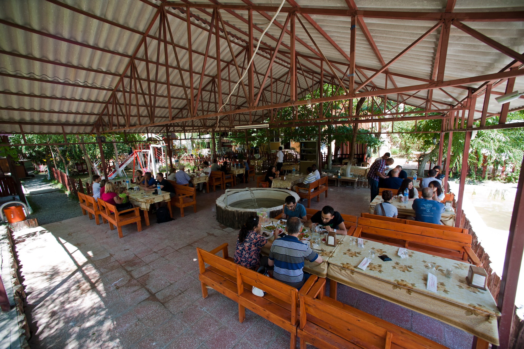 Visitors to Saklibahce sit in one of the picnic areas Aug. 11, 2013, at Pozanti, Turkey. All of the food served at Saklibahce was harvested on location. (U.S. Air Force photo by Senior Airman Daniel Phelps/Released)