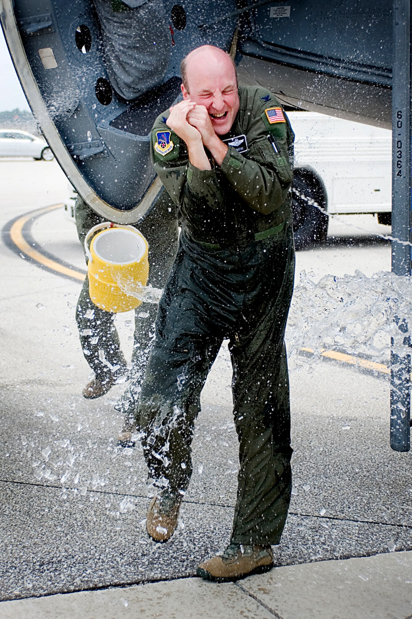 Col. Chris Amend, 434th Operations Group commander, reacts as he is doused with water upon landing at Grissom Air Reserve Base, Ind., Aug. 7, 2013 for his final flight. Amend celebrated the moment with unit members, friends and family before he departs to Scott AFB, Ill., where he will serve as the reserve advisor to the commander of Air Mobility Command. (U.S. Air Force photo/Tech. Sgt. Mark R.W. Orders-Woempner)