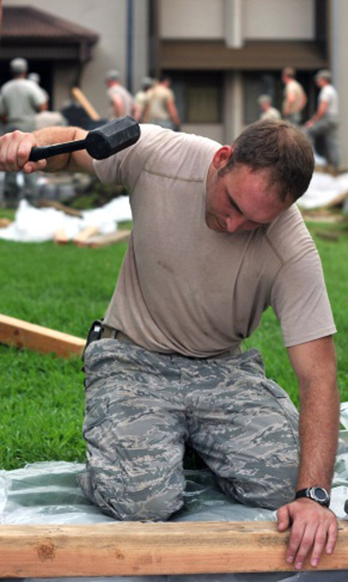 Staff Sgt. Jacob Sober, hammers down some wood for the new horseshoe ring area at Bld. 1349 at Osan Air Base, Republic of Korea, Aug. 16, 2013. Seventy-five Airmen assisted with the CES renovation project at the dorm. (U.S. Air Force photo/Senior Airman Kristina Overton)