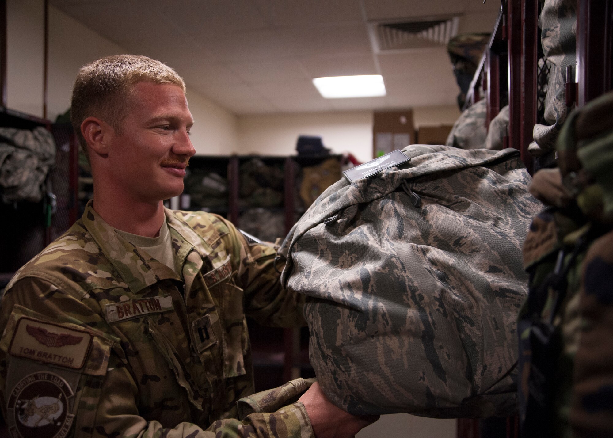 Capt. Thomas Bratton grabs equipment from aircrew flight equipment prior to departure for a C-130 Hercules mission at the 379th Air Expeditionary Wing in Southwest Asia, Aug. 14, 2013. Bratton is a 746th Expeditionary Airlift Squadron C-130 co-pilot deployed from Peterson Air Force Base, Colo., and a Zeeland, Mich., native. (U.S. Air Force photo/Senior Airman Bahja J. Jones) 