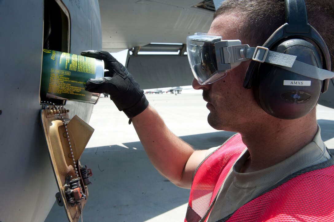 Senior Airman John Swank replaces the oil in a KC-135 Stratotanker engine during a thru flight inspection at the 379th Air Expeditionary Wing in Southwest Asia, Aug. 13, 2013. Swank is a 340th Expeditionary Aircraft Maintenance Unit crew chief deployed from Forbes Field Air National Guard Base, Kan., and a Topeka, Kan., native. (U.S. Ai Force photo/Senior Airman Bahja J. Jones) 