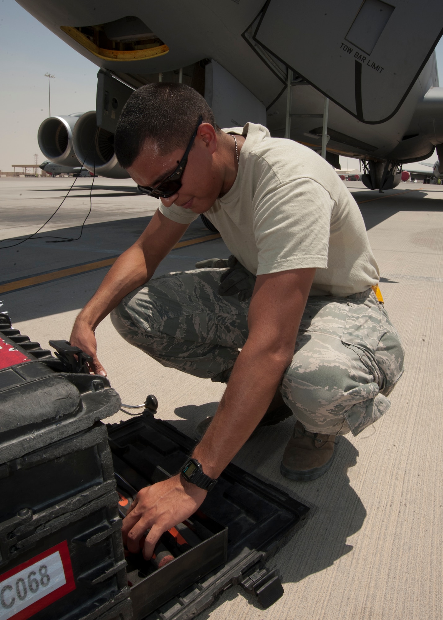 Airman 1st Class Marcus Torres selects a tool from a kit to be used during a KC-135 thru flight inspection at the 379th Air Expeditionary Wing in Southwest Asia, Aug. 13, 2013. Torres is a 340th Expeditionary Aircraft Maintenance Unit crew chief deployed from McConnell Air Force Base, Kan., and a Tucson, Ariz., native. (U.S. Air Force photo/Senior Airman Bahja J. Jones) 