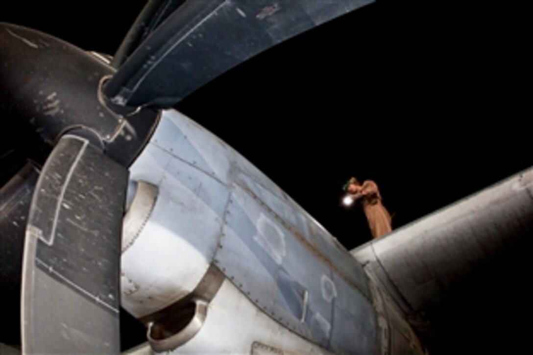 U.S. Marine Corps Sgt. Michael C. Doucette inspects a KC-130J Hercules aircraft on Camp Bastion in Afghanistan's Helmand province, Aug. 15, 2013.Doucette is assigned to Marine Aerial Refueler Transport Squadron 252.
