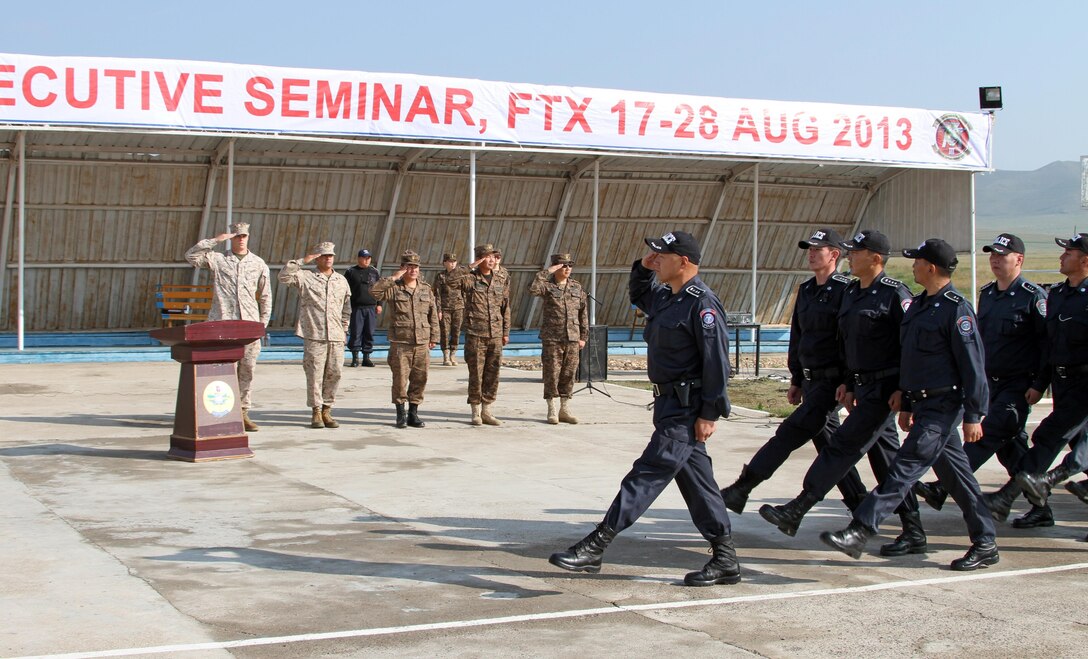 Mongolian Police march during the pass and review portion of the opening ceremony of Non-Lethal Weapons Executive Seminar (Knoles) in Five Hills Training Area, Mongolia, August 17, 2013. Knoles is a regularly scheduled field training exercise and leadership seminar sponsored annually by U.S. Marine Corp Forces Pacific, and it is designed to promote awareness and effective use of non-lethal weapons as a tool to maintain order in low-intensity or civil unrest situations.(U.S. Marine Corps Photo by Sgt John M. Ewald/released)