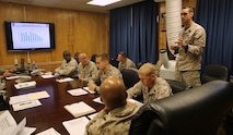 The acting commander of Medical Logistics Company, 2nd Supply Battalion, 2nd Marine Logistics Group discusses medical care within the battalion at the weekly command and staff meeting during the unit’s non-commissioned officer, or NCO, day aboard Camp Lejeune, N.C., Aug. 14, 2013. Non-commissioned officers and petty officers stepped into the positions of their units’ commanders and staff NCOs for the duration of the event.