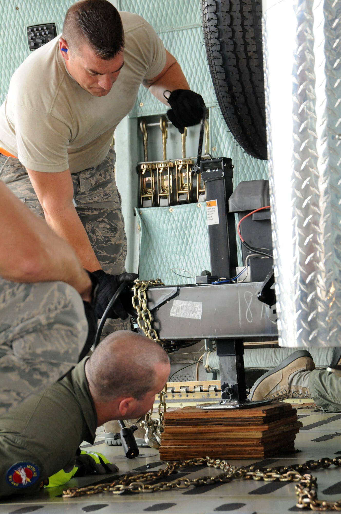 Master Sgt. Jason Kerstetter (top left), 193rd Special Operations Logistics Readiness Squadron, secures a trailer for transport on a C-5 during a Homeland Response Force exercise involving personnel and equipment from the 193rd Special Operations Wing and other National Guard units from Pennsylvania and surrounding states. (U.S. Air National Guard photo by Staff Sgt. Susan Penning/Released)