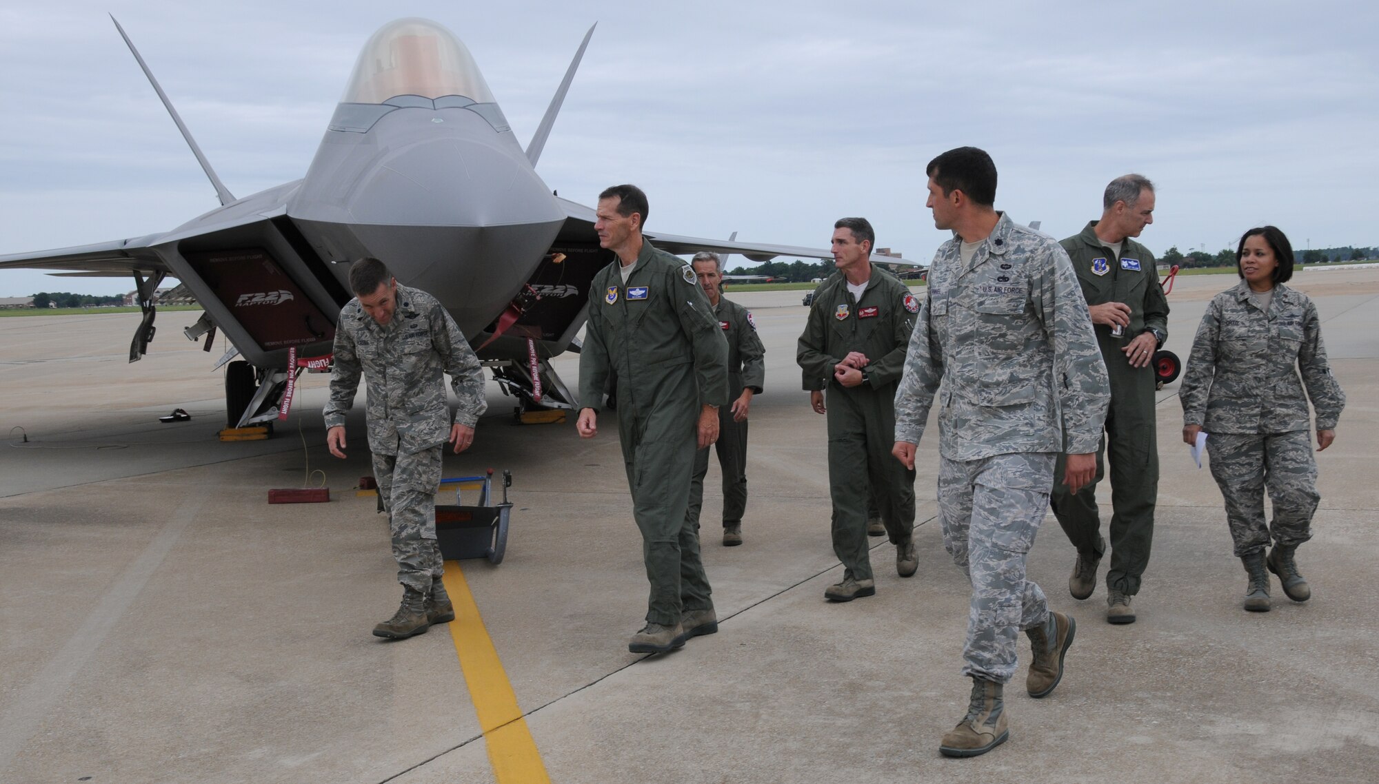 Lt. Gen. Stanley E. Clarke III (middle), director of the Air National Guard walks the aircraft ramp with 192d Fighter Wing leadership, during a visit to Joint Base Langley-Eustis, Va., Aug. 16. The visit is Clarke's first to the Virginia Air Guard since becoming director. During the visit, Clarke met with Airmen from the low observables section and the intelligence squadron where he listened to Airmen talk about the Total Force Integration with the 1st FW. (U.S. Air National Guard photo by Master Sgt. Carlos Claudio/Released).