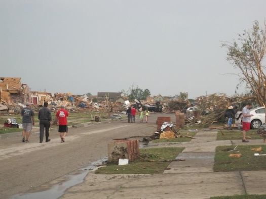 Residents of Moore, Okla., survey the damage to their neighborhood after a massive 1.3-mile-wide tornado touched down May 20, 2013. Staff Sgt. Tim Smith helped rescue his neighbors and children from the local school from the rubble. Smith is a , 349th Recruiting Squadron enlisted accessions recruiter. (U.S. Air Force photo/Staff Sgt. Brandi Smith)
